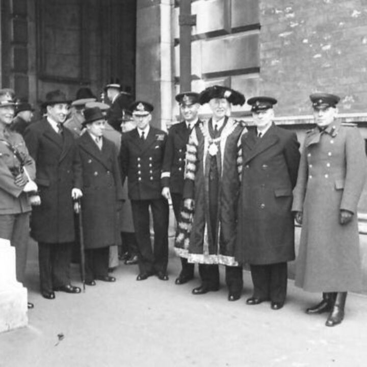 The Right Honourable Sir Basil Brooke (Prime Minister of Northern Ireland), Lieutenant General Sir Alan Gordon Cunningham K.C.B, D.S.O., M.C. (General Officer Commanding Northern Ireland), Mr. Albert Victor Alexander (First Lord of the Admiralty), Colonel Alexander Vasilyevich Gorbatov (Soviet Army), Captain Vladimir Ivanovich Voronin (Soviet Navy), and Sir Crawford McCullagh (Lord Mayor of Belfast) are among the dignitaries at a parade marking the 26th anniversary of the Red Army at Belfast City Hall, Belfast.