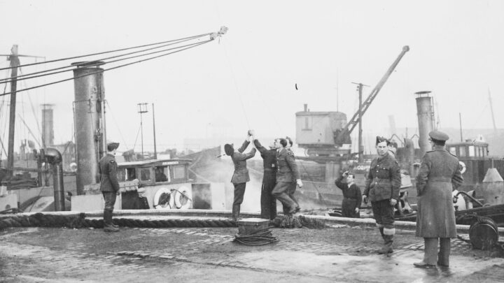 Members of No. 968 Barrage Balloon Squadron in Bangor, Co. Down working on Archimedes, a boat requisitioned for use as a waterborne barrage balloon vessel on Belfast Lough.